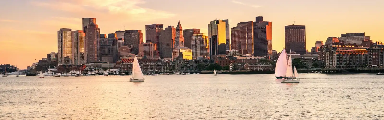 Boston skyline at sunset. Find Massachusetts insurance.