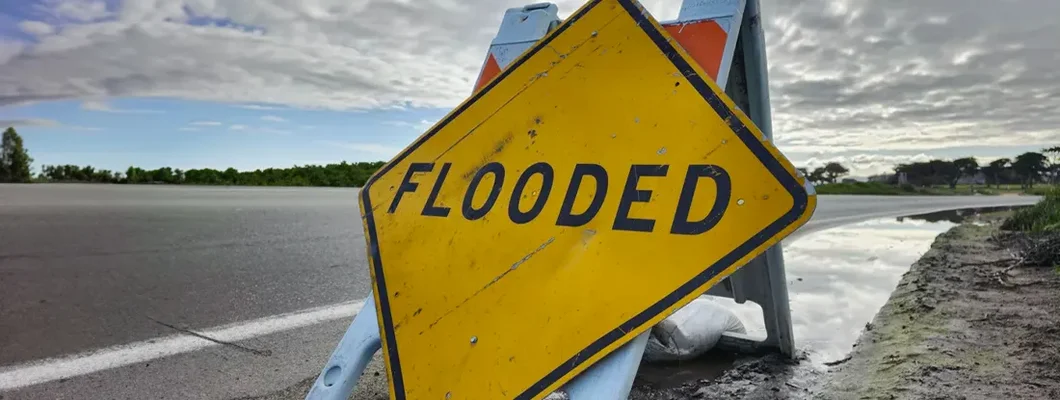 Flooded sign on the road. Find Alabama Flood Insurance.