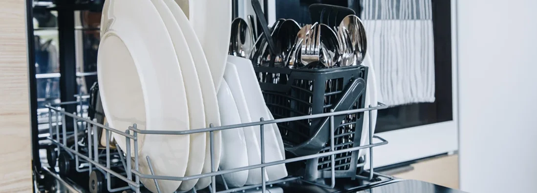 Open dishwasher with clean glasses and dishes close-up. If My Dishwasher Leaks and Floods My Massachusetts Home, Who Pays for the Damage?