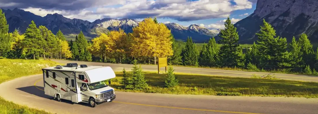 Recreational Vehicle Driving on Autumn Highway In Beautiful Mountains Wilderness. Get RV Insurance Quotes.