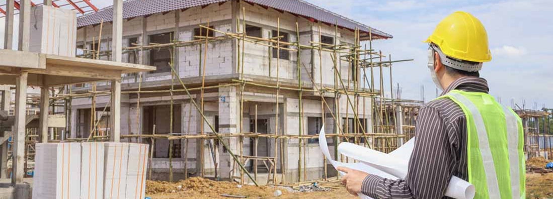 New home construction site with contractor in foreground. Find General Contractor Insurance.