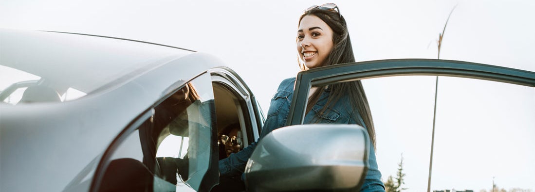 Group of Young Adults Having Fun Riding in Car. Find Good Student Discounts.