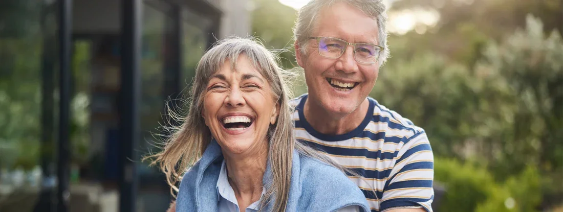 Happy mature couple at home. Paid Up Life Insurance.