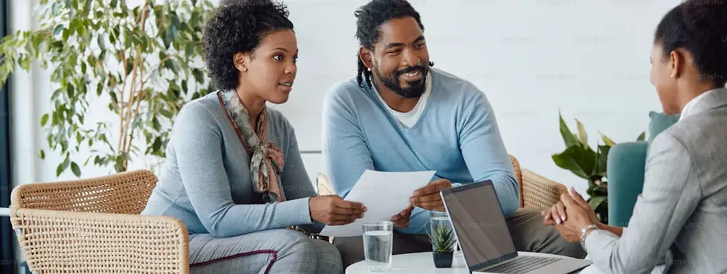 Man and his wife analyzing documents during a meeting with their financial consultant in the office. Find Ohio Landlord Insurance.