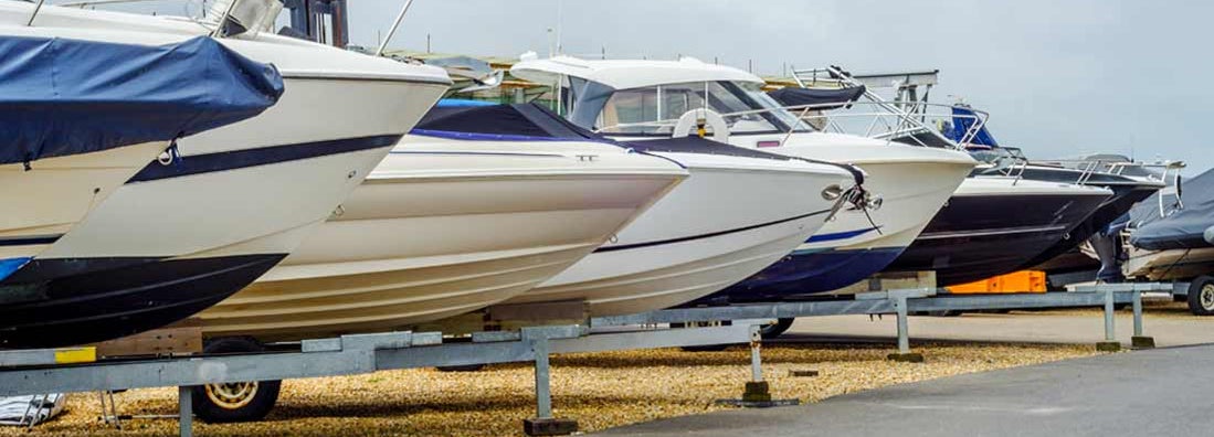 Boats on stands on shore. Find Boat Dealer Insurance.