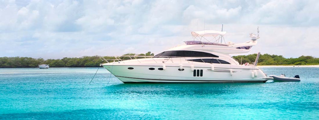 Luxury Yacht anchored in a tropical exotic island beach. Find Yacht Insurance.