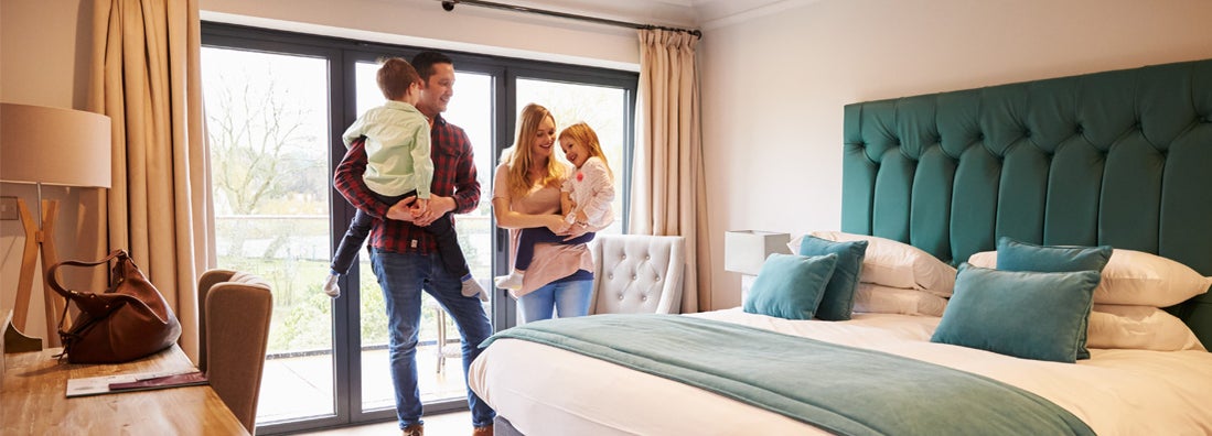 Family Arriving In Hotel Room