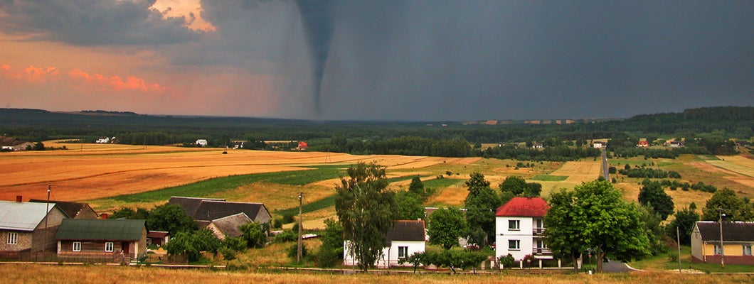 View of countryside with a tornado in the background