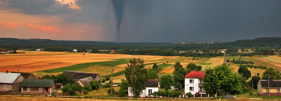 View of countryside with a tornado in the background