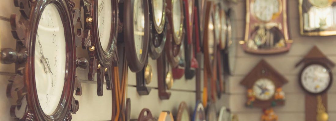 Clocks hanging on wall at clock shop