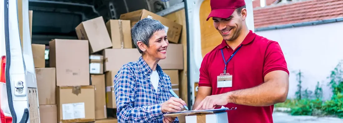 Woman signing for her delivery from the courier. Find Alabama Commercial Vehicle Insurance.