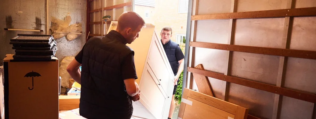 Men loading furniture into removal truck. Find Moving Insurance.