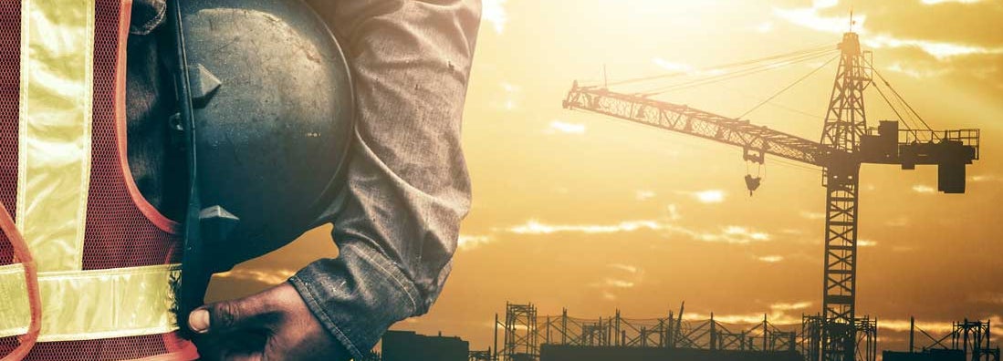 Construction Worker Overlooking Building Site. Find Crane Insurance.