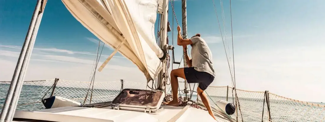 Man sailing and fishing during summer holidays. Find Boat Insurance Claims.