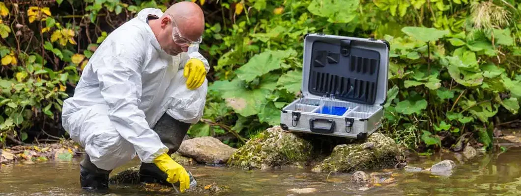 Scientist examing toxic water. Find Environmental Consulting Insurance.