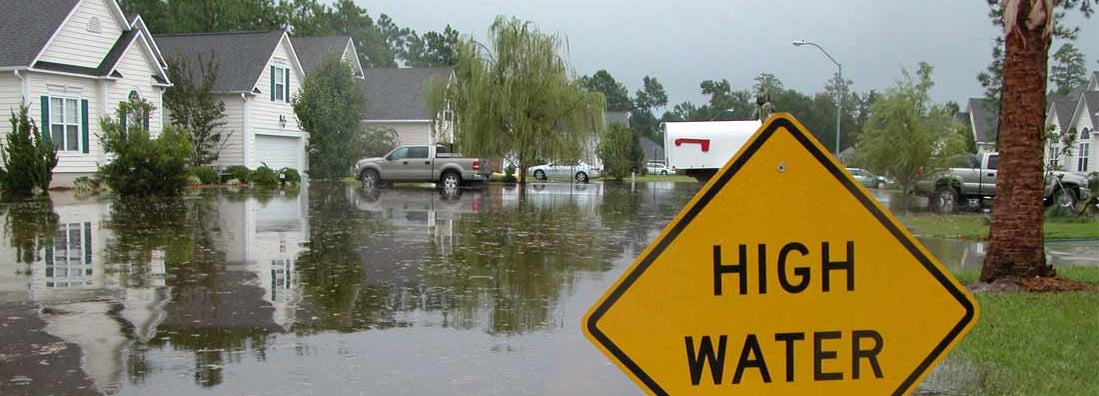 High Water Sign in Flooded Neighborhood