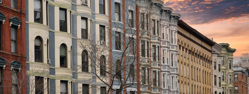 Street of well preserved old apartment buildings. Compare renters insurance.