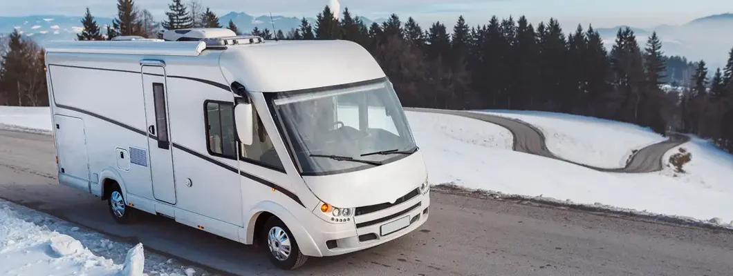 Man driving a luxury RV in the winter. Find Rhode Island RV Insurance.