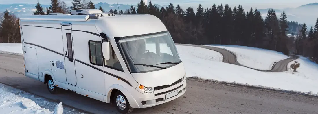 Man driving a luxury RV in the winter. Find Rhode Island RV Insurance.