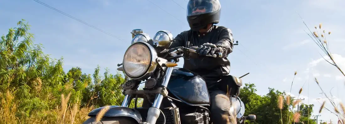 Motorcyclist on asphalt country road. Find Illinois Motorcycle Insurance.