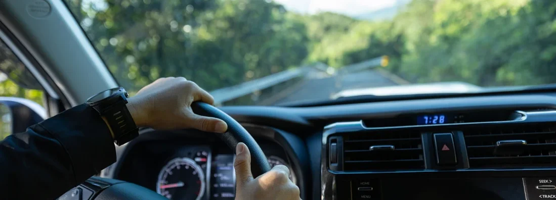 Man driving car on mountain road. Find Lake Oswego, Oregon car insurance.