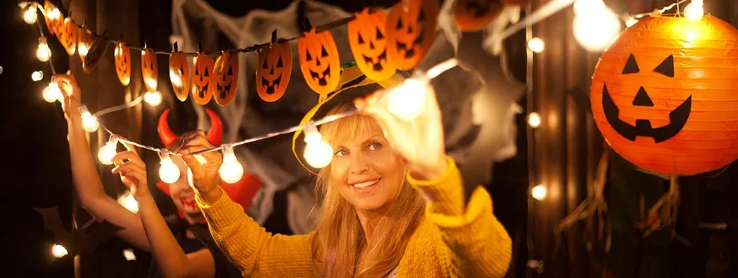 Mom and daughter decorate for Halloween. Safety Tips for Halloween.