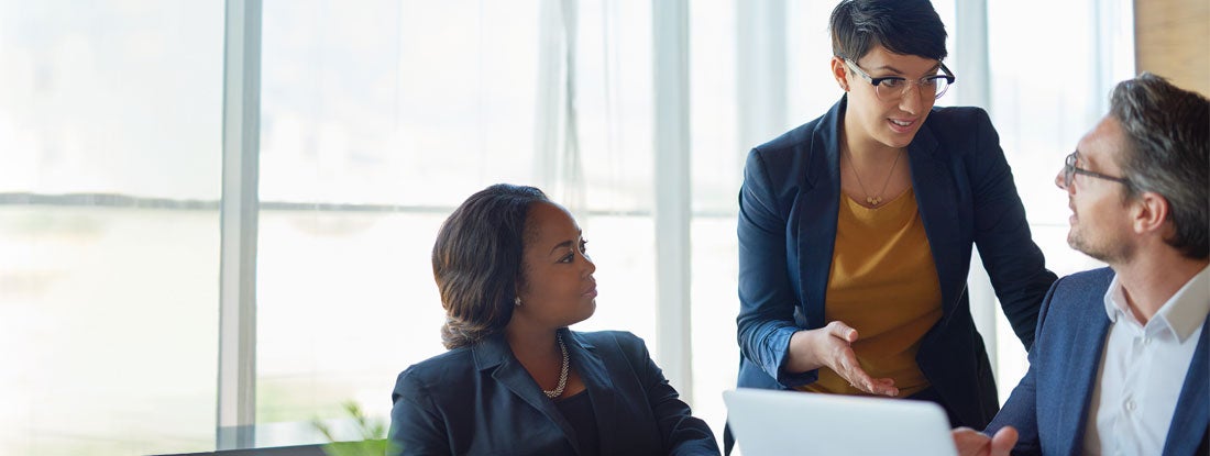 Employees having discussion in office about benefits