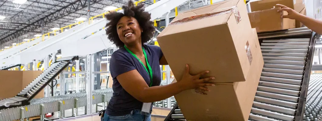 Cheerful Warehouse Employee Loading Boxes Into Truck. South Portland, Maine Business Insurance.