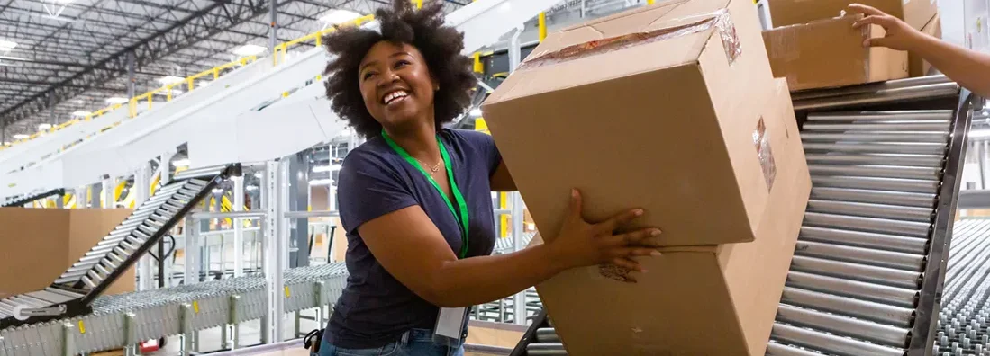 Cheerful Warehouse Employee Loading Boxes Into Truck. South Portland, Maine Business Insurance.