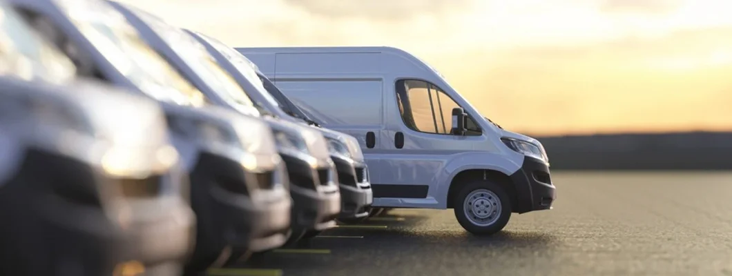 Generic row of new vans parked. Find North Carolina Commercial Vehicle Insurance.