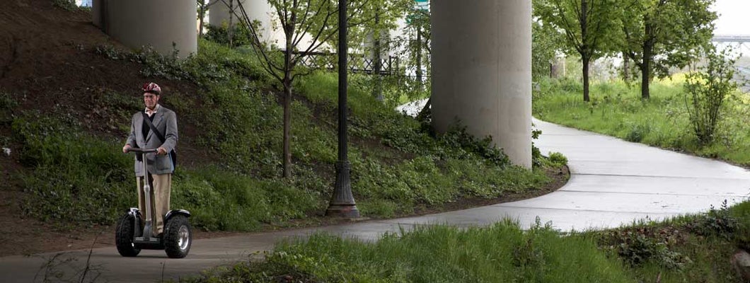 Senior man riding segway under underpass. Find Segway Insurance.