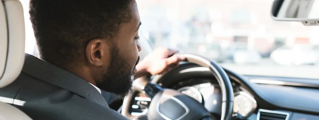 Businessman touching dashboard in car. How to Find the Best Car Insurance Policy in Morrisville, North Carolina.