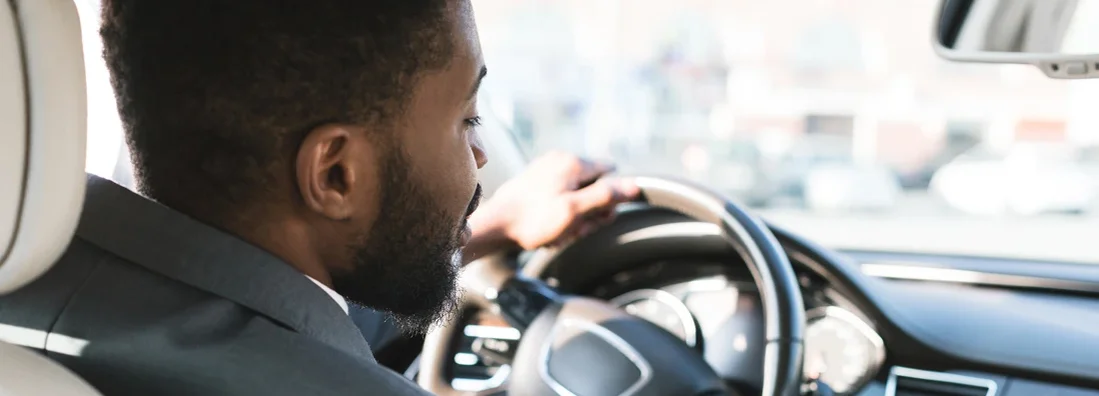 Businessman touching dashboard in car. How to Find the Best Car Insurance Policy in Morrisville, North Carolina.
