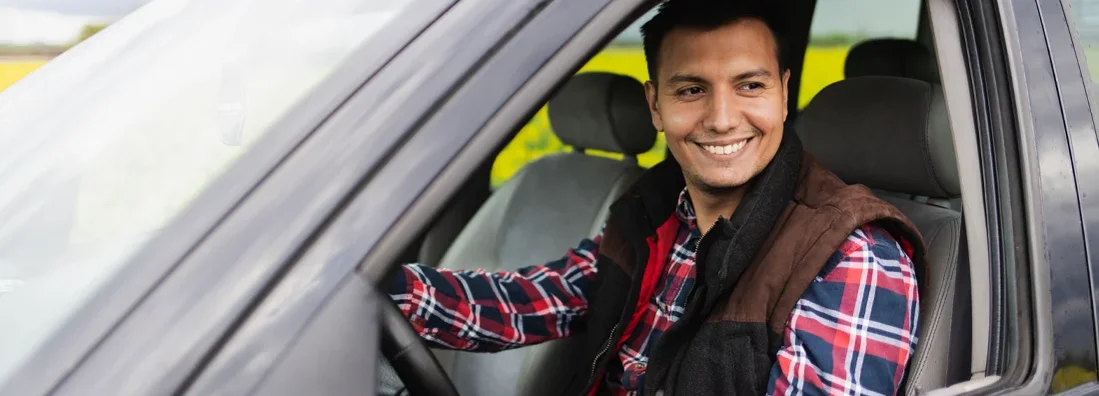 Young farmer sitting in an off road SUV vehicle. Southlake, Texas Car Insurance.