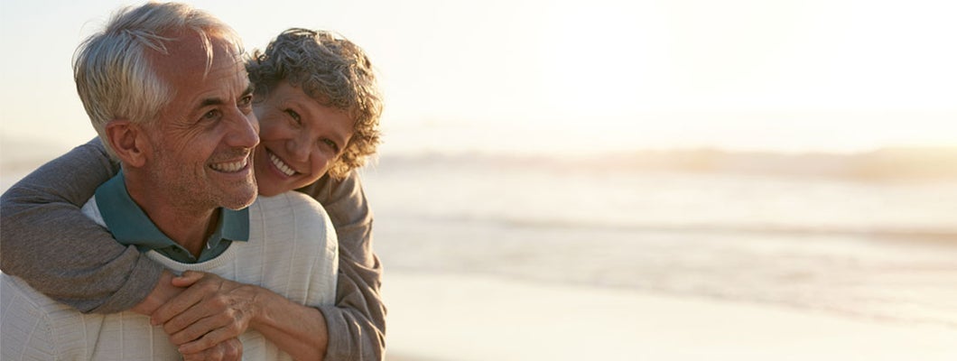 Senior couple having fun at the beach. Find California life insurance.