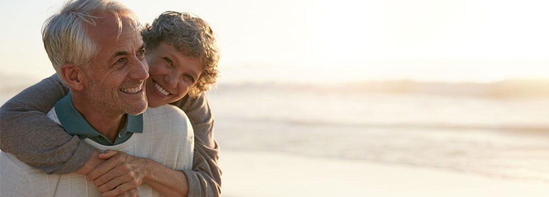 Senior couple having fun at the beach. Find California life insurance.