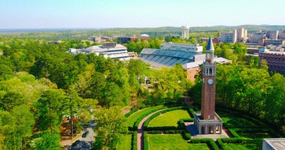 Aerial shot at UNC of the campus bell tower and football stadium.