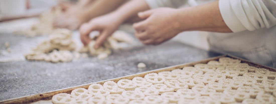 Women working together making pretzels