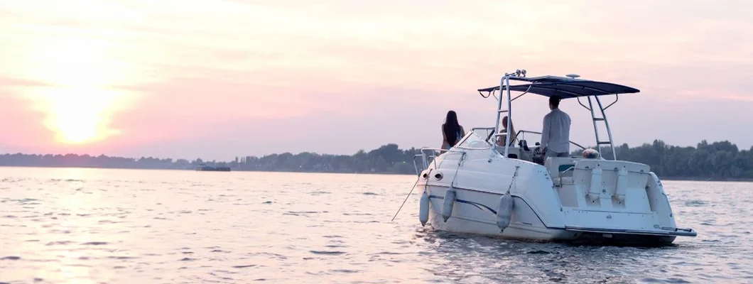 Friends on yacht , smiling and talking. Find North Dakota Boat Insurance.