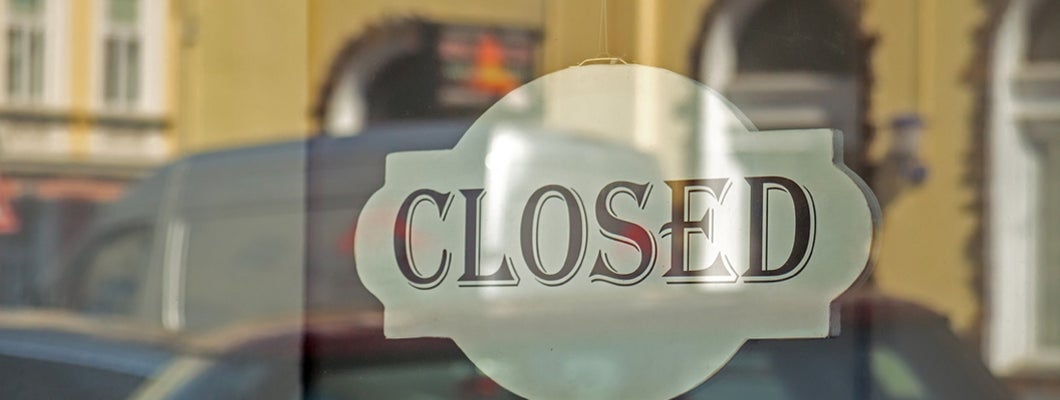 Closed sign on shop glass front door