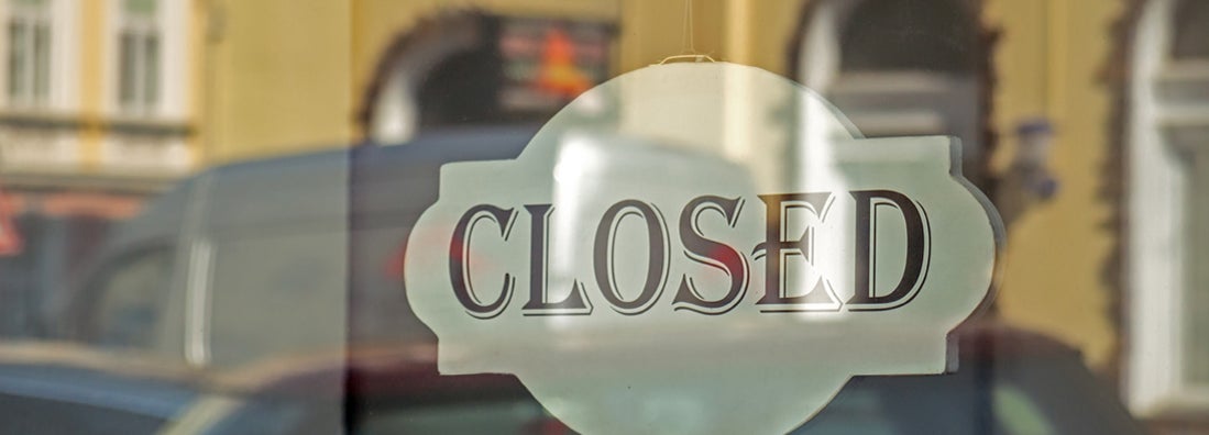 Closed sign on shop glass front door