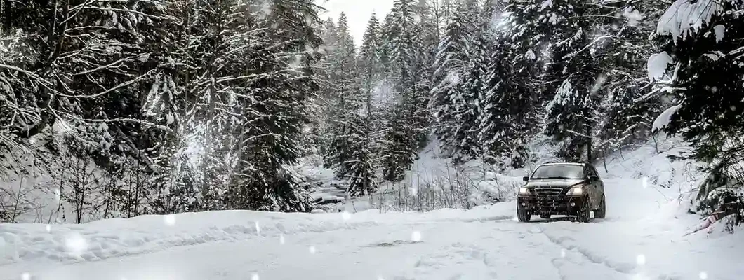 Off road car in the winter forest. 10 Tips for staying safe on the road in the winter.