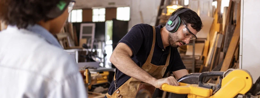 Woodworkers Crafting in a Busy Sustainable Workshop Environment. Find Workers' Comp Insurance for Small Businesses.