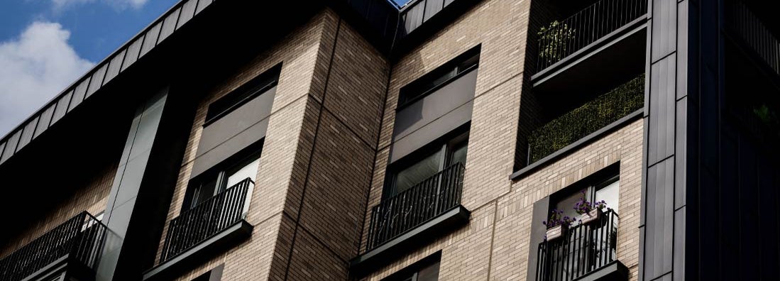 Modern brick apartment building exterior. Find New Hampshire renters insurance.