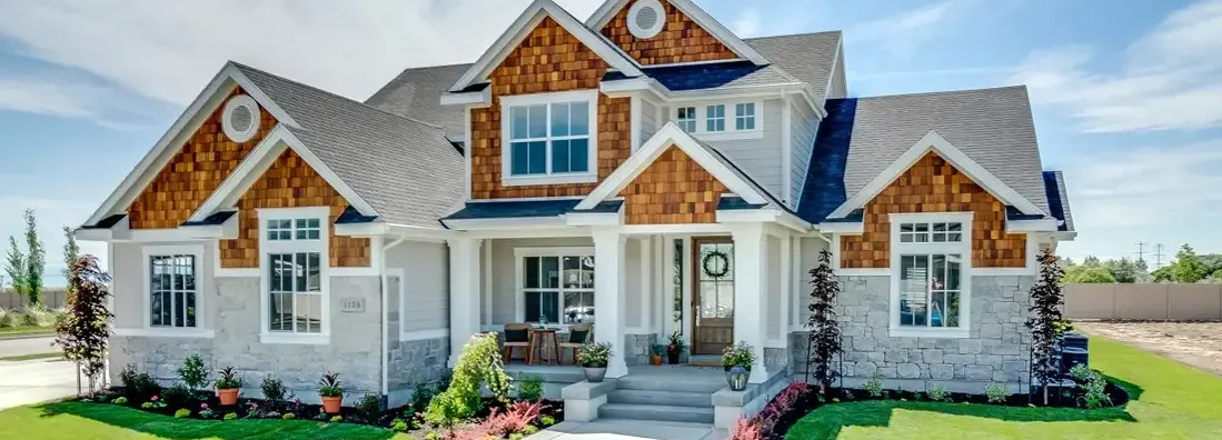 Traditional home with natural wood, siding and stone exterior. How to buy homeowners insurance.