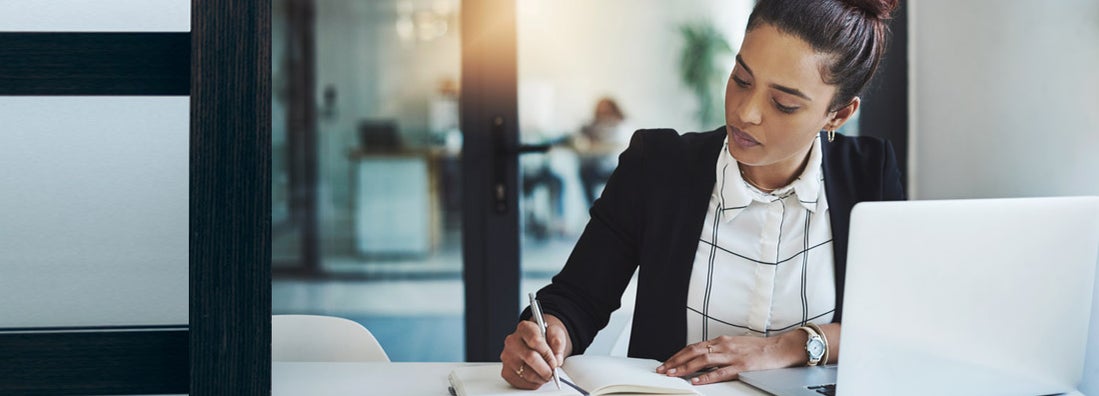 Woman writing resume. Find cover letter and resume writing service insurance
