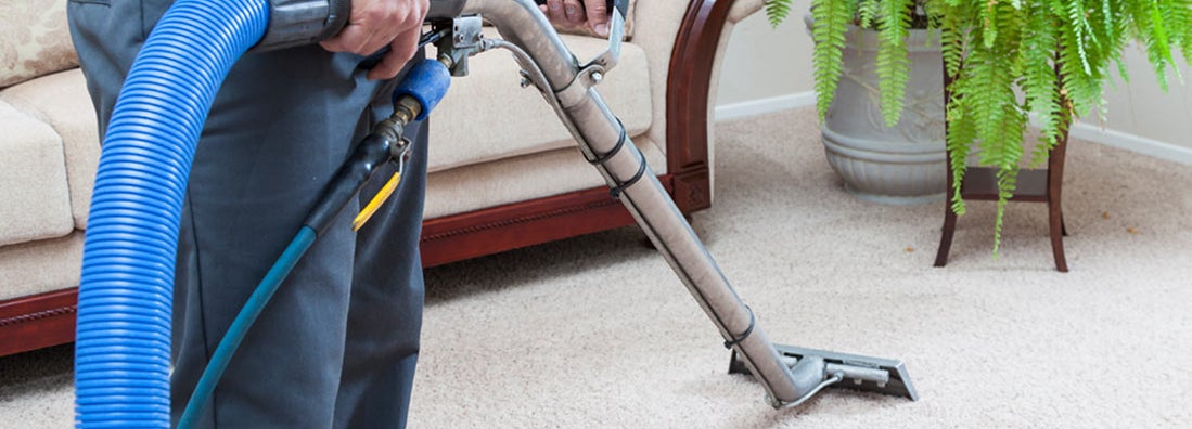 Man cleaning carpets in home. Find home carpet cleaning insurance.