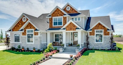 Traditional home with natural wood, siding and stone exterior. How to buy homeowners insurance.