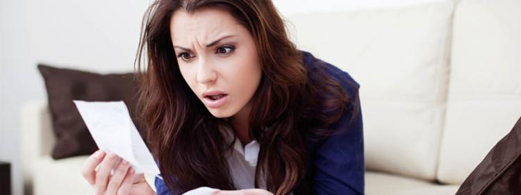 Stressed young woman paying bills