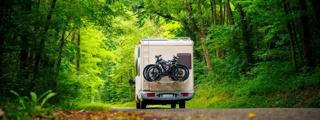 Motor home in the forest. Best RV Insurance Companies.